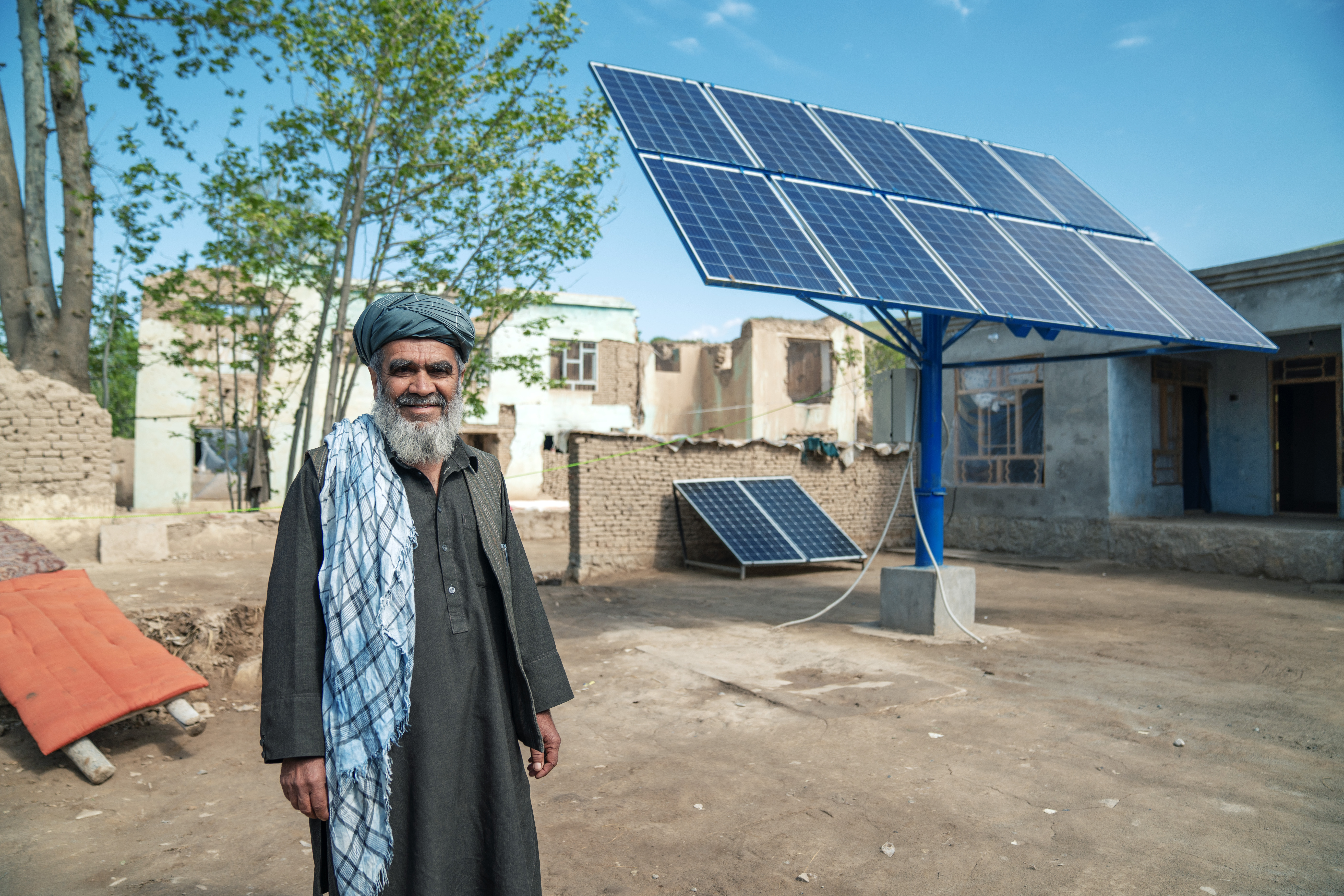 O pátio da casa onde Muhammad Zubaid cresceu alberga agora dois painéis solares gigantes que alimentam o sistema de água da aldeia.